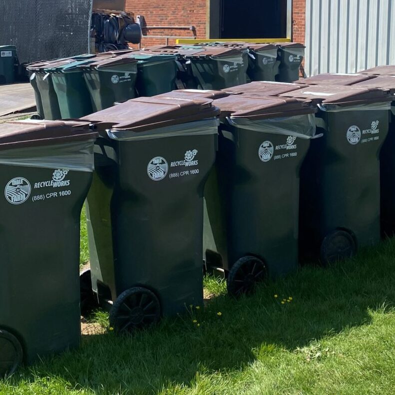 Recycleworks totes/barrels for organic waste lined up outside