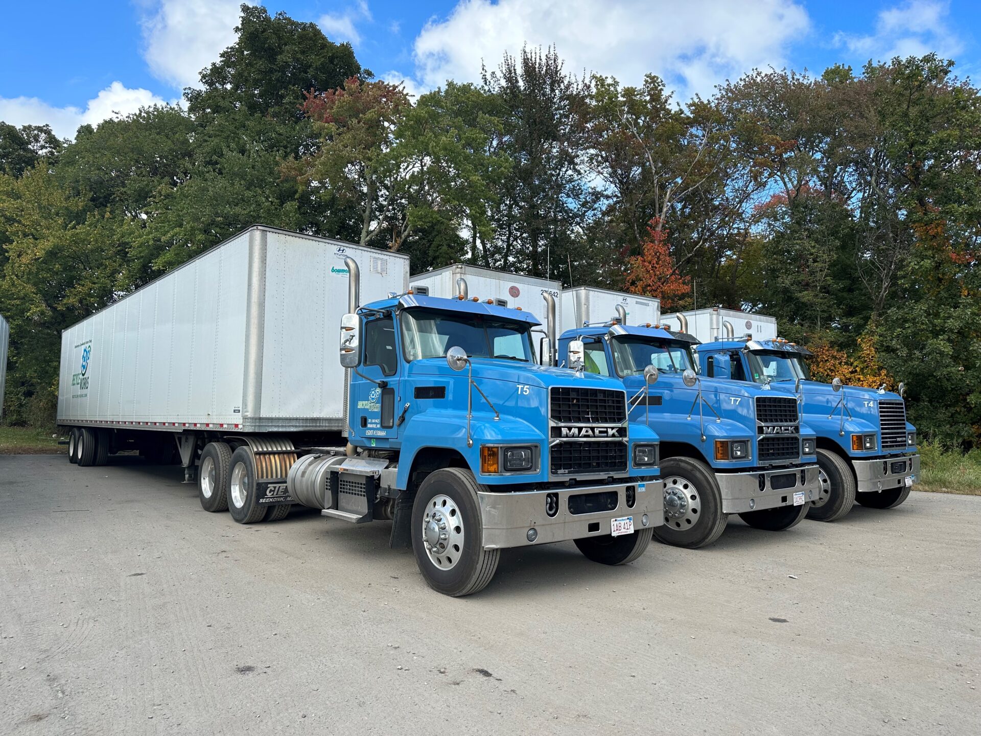 three Recycleworks tractor trailers lined up next to each other